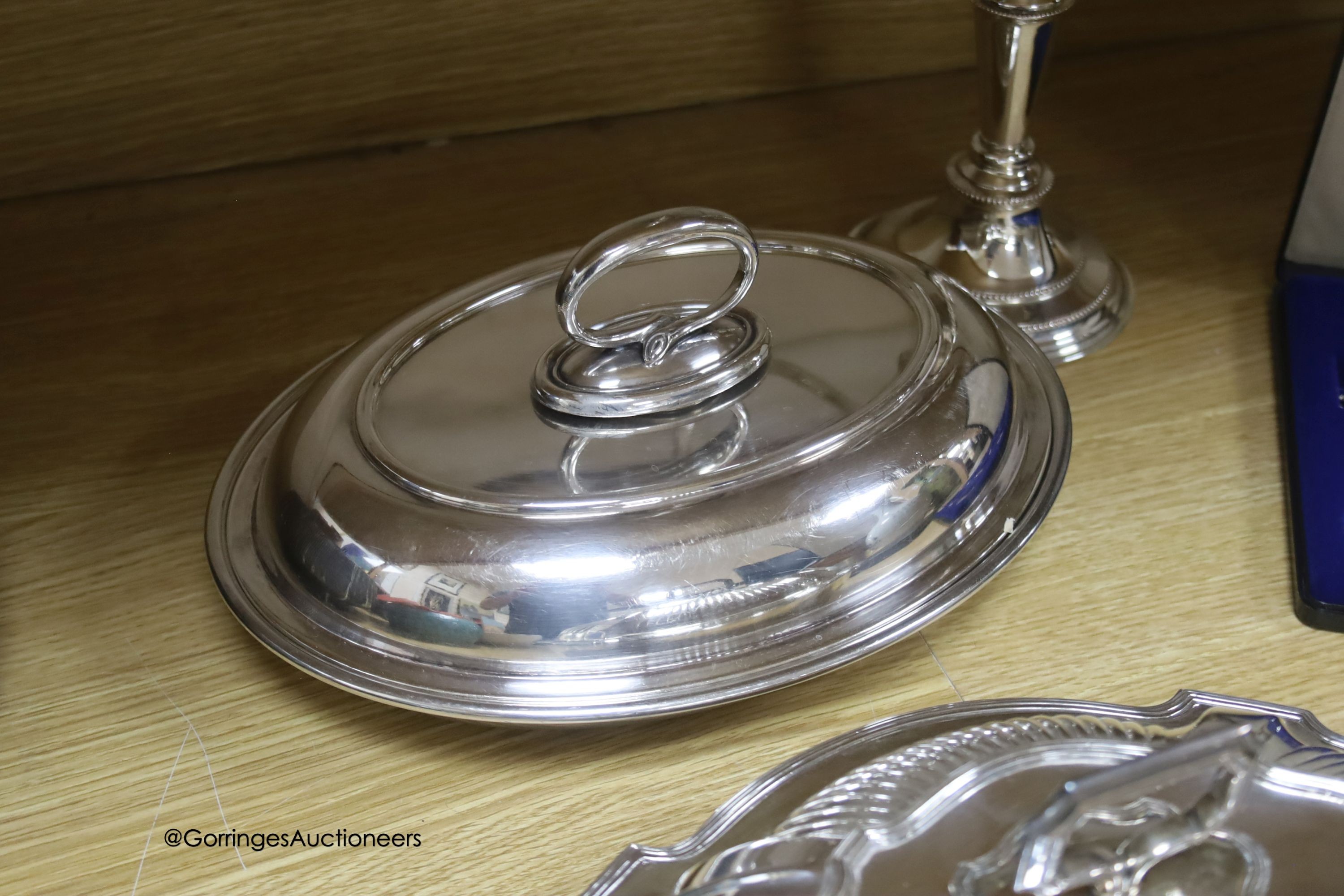 A group of plated ware including a pair of Georg Jensen salad servers